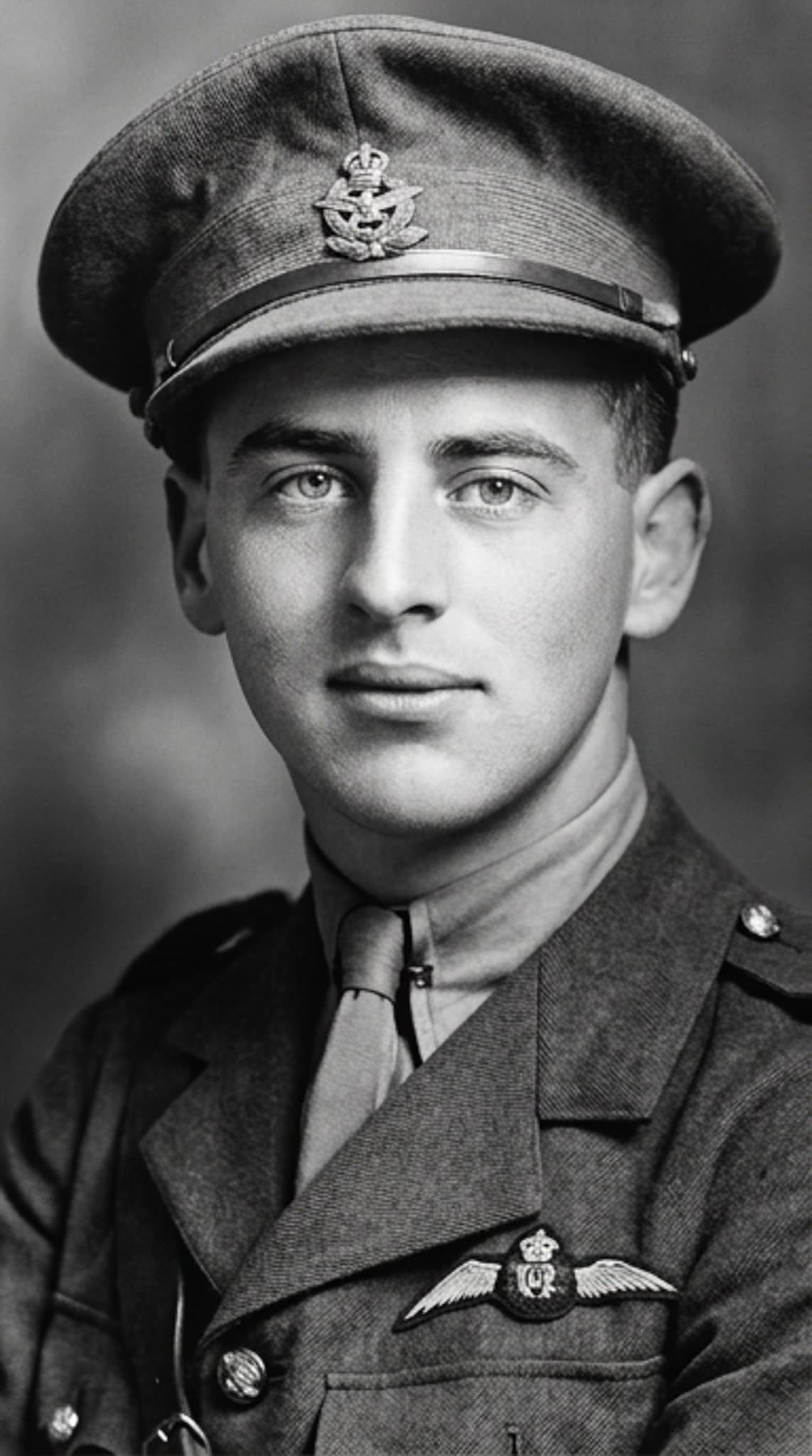 Studio portrait of Captain Carl Falkenberg in military aviator uniform, wearing a peaked cap and pilot's wings.